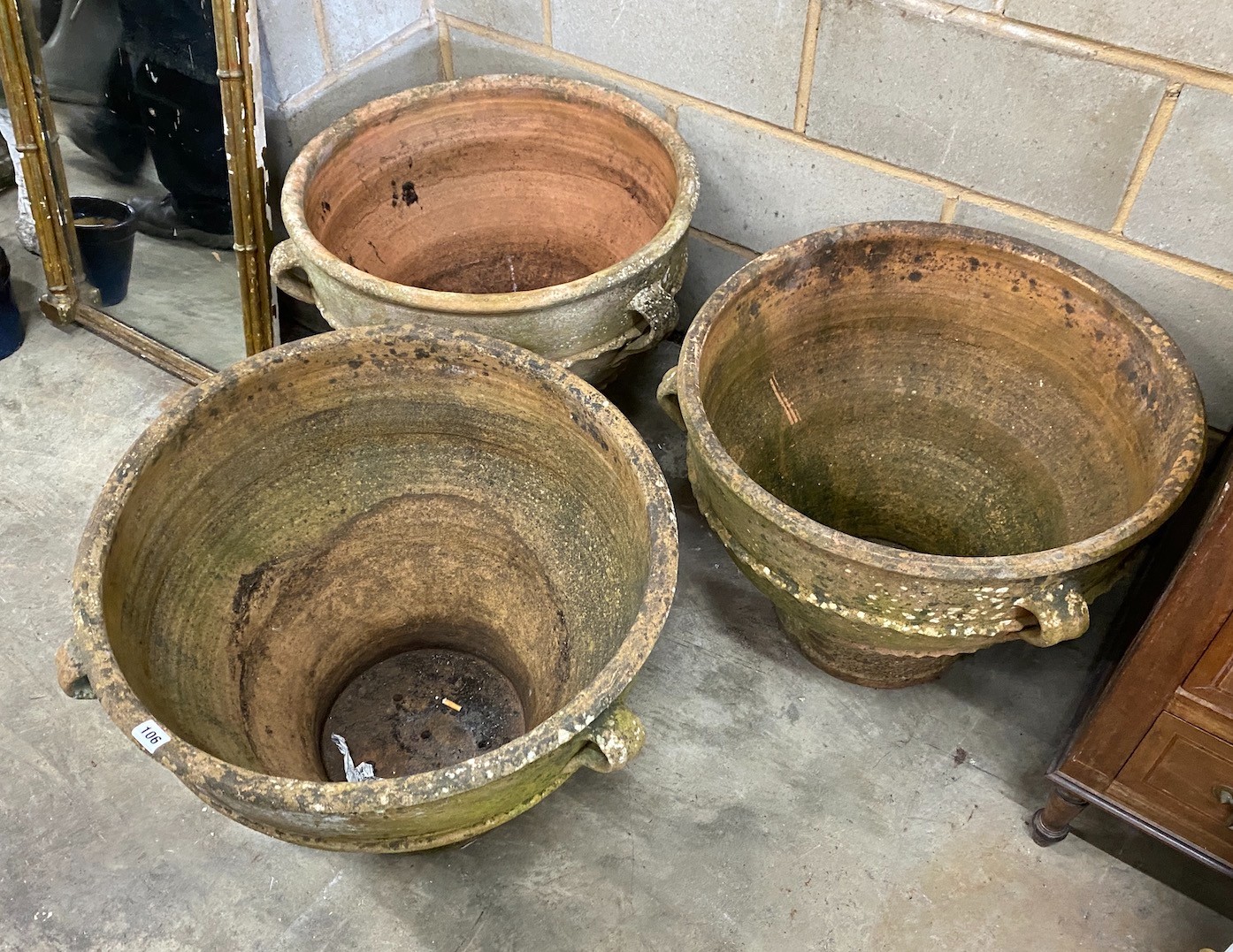 A set of three Greek style circular terracotta planters, diameter 62cm, height 50cm